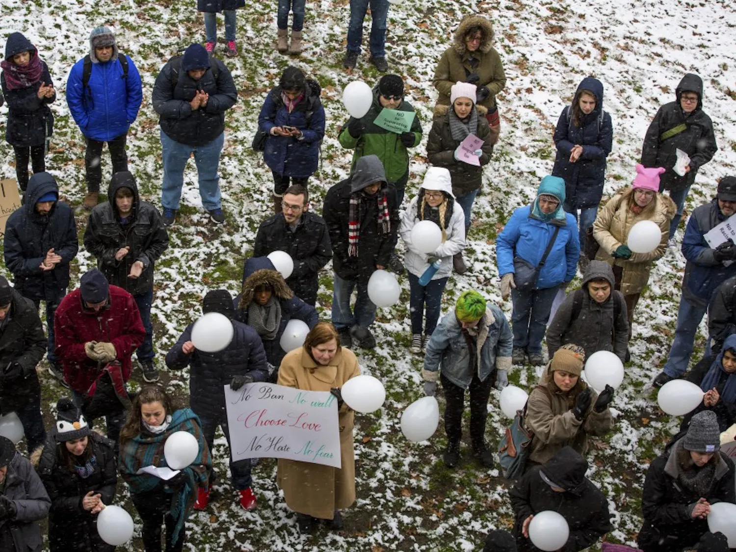 Students, faculty and community members gather on a snowy College Green near Templeton-Blackburn Alumni Memorial Auditorium during an Academics United - No Visa and Immigration Ban rally on Feb. 9. Rallies took place on more than 50 campuses across the U.S., according to the Facebook event.