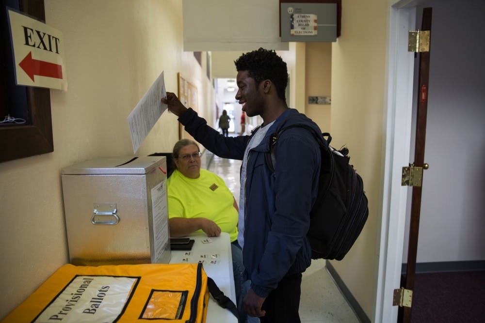 Austin Rivers, a senior from South Carolina, drops his vote in the ballot box on Tuesday. Ohioans can now register to vote online but you have to have a valid ID. 
