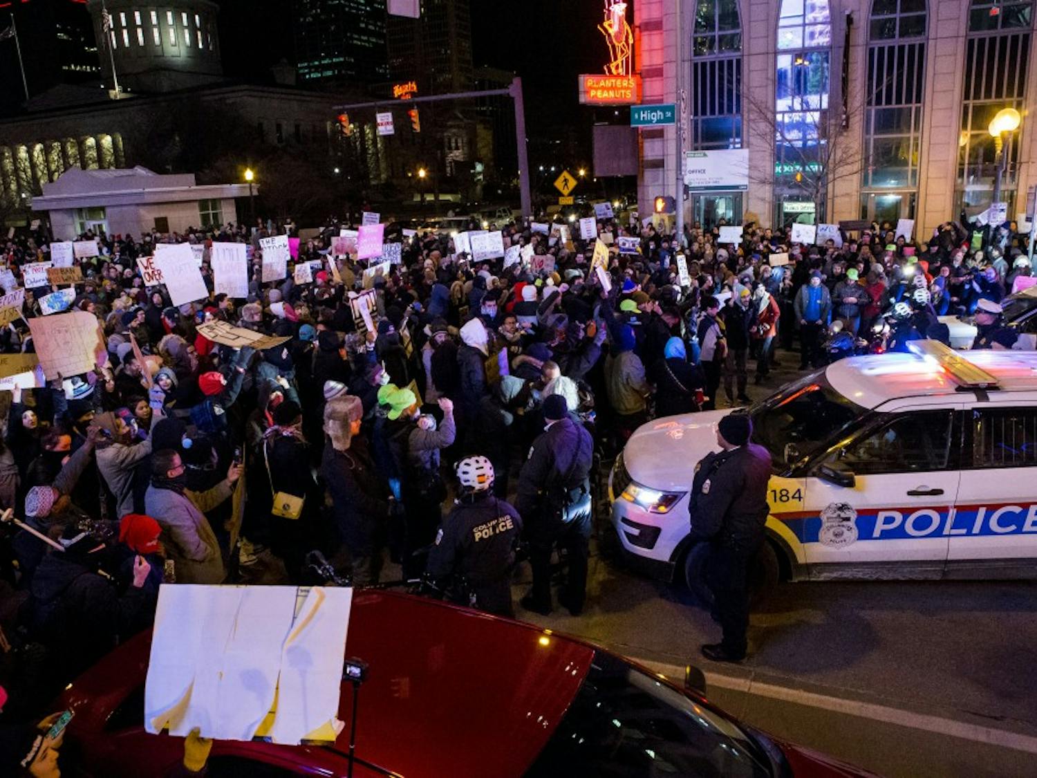 Police stand by while protesters block the intersection of South High and State streets in Columbus&nbsp;during a Resist Trump Rally in Columbus on Monday, Jan. 30, 2017.