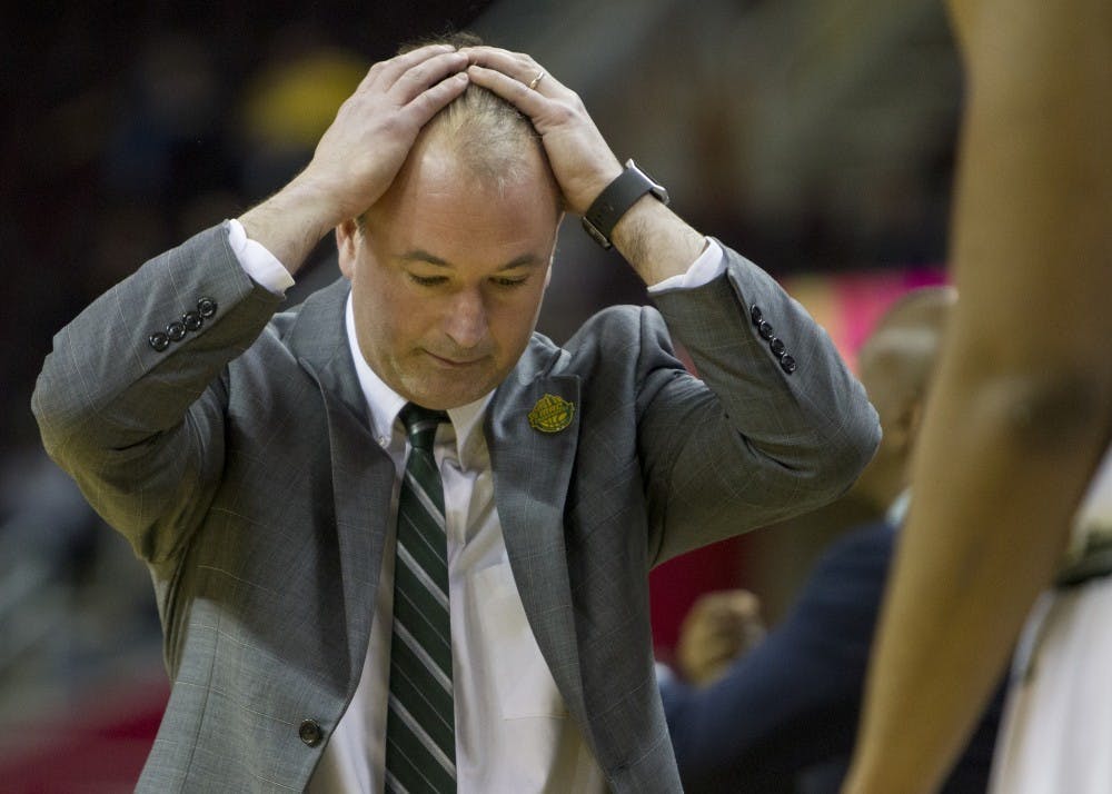 Ohio head coach Saul Phillips hangs his head in disbelief after a foul was called in Kent State's favor late in the second half of the Bobcat's 68-66 loss in the MAC Tournament semifinal. 