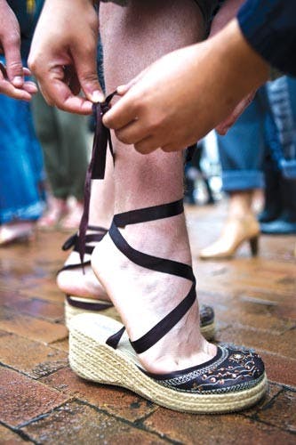 Men don women's footwear during 5th annual Walk a Mile in Her Shoes march  