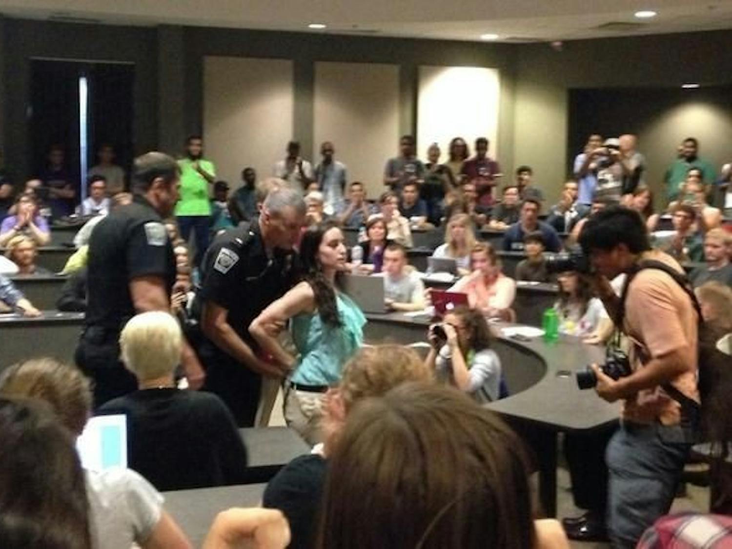 Bobcats for Israel President Becky Sebo being escorted out of Wednesday's senate meeting  