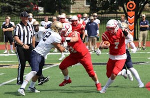 Luke Schmeling (#7) rushes against John Carroll