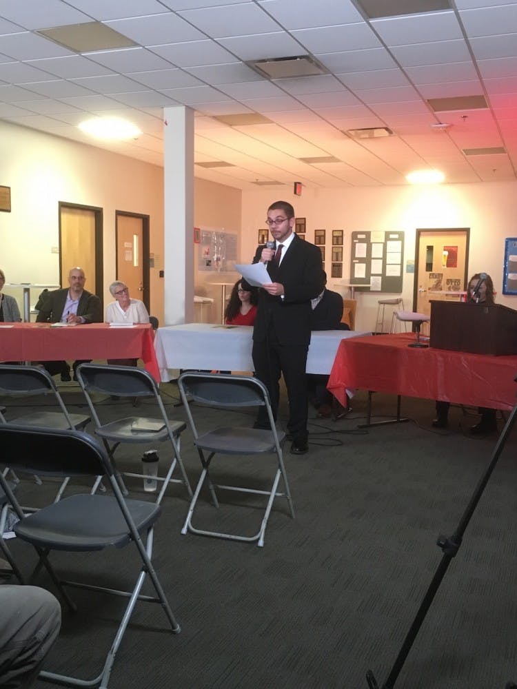 Senior communication major Rease Johnson announces the start of the debate.