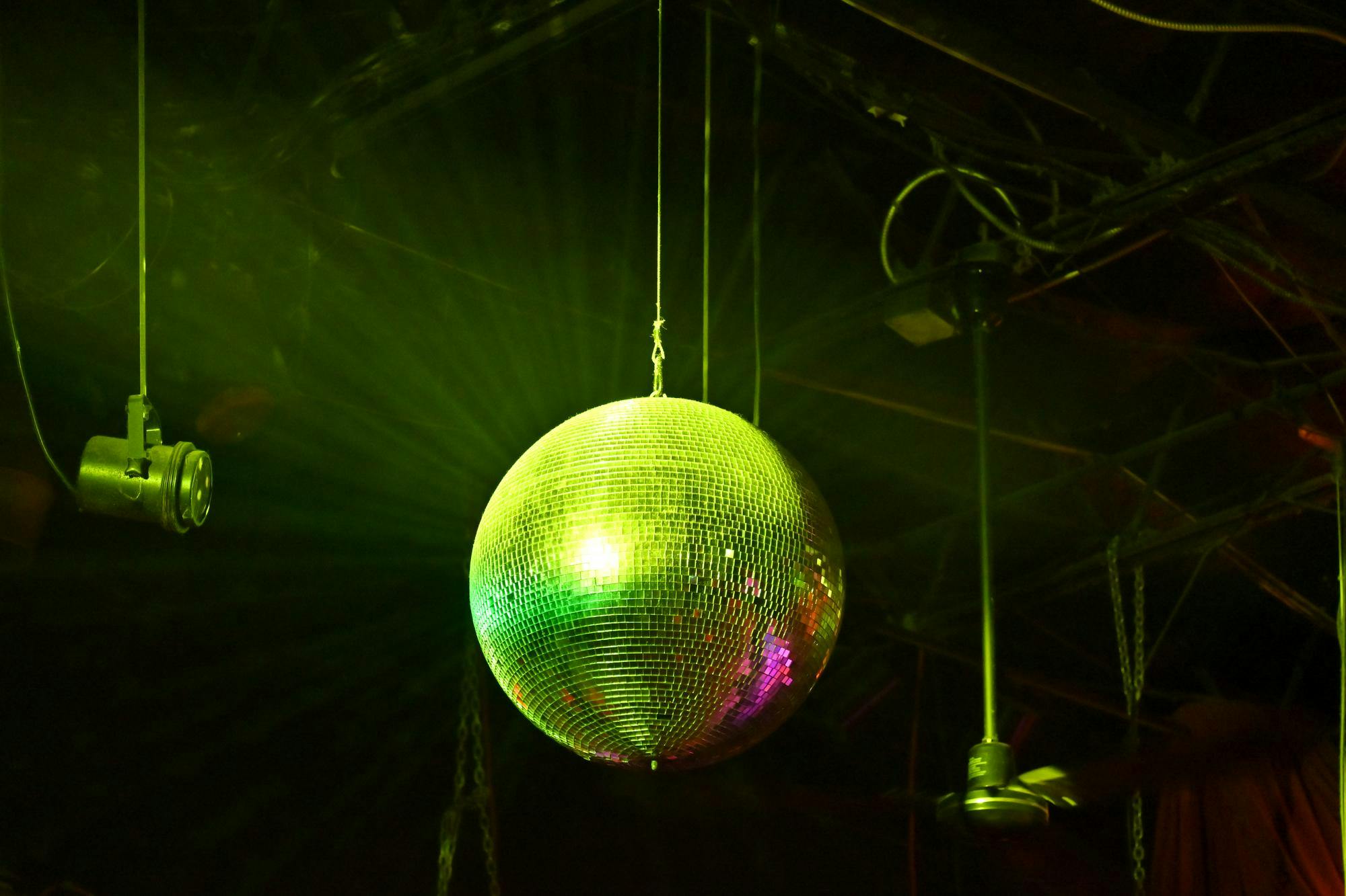 Image of Disco ball shining with green strobe lights at Skully’s Music Bar. Photo taken by Angelina Godfrey on Feb. 23, 2025