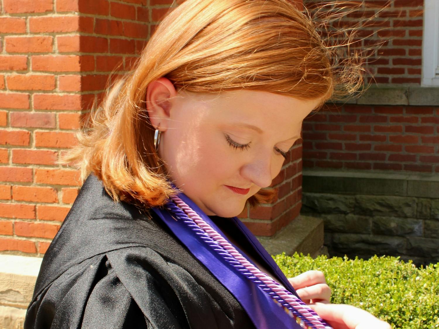 Shay Locke dons their graduation cords prior to the ceremony, which is to be held on May 1, 2022.