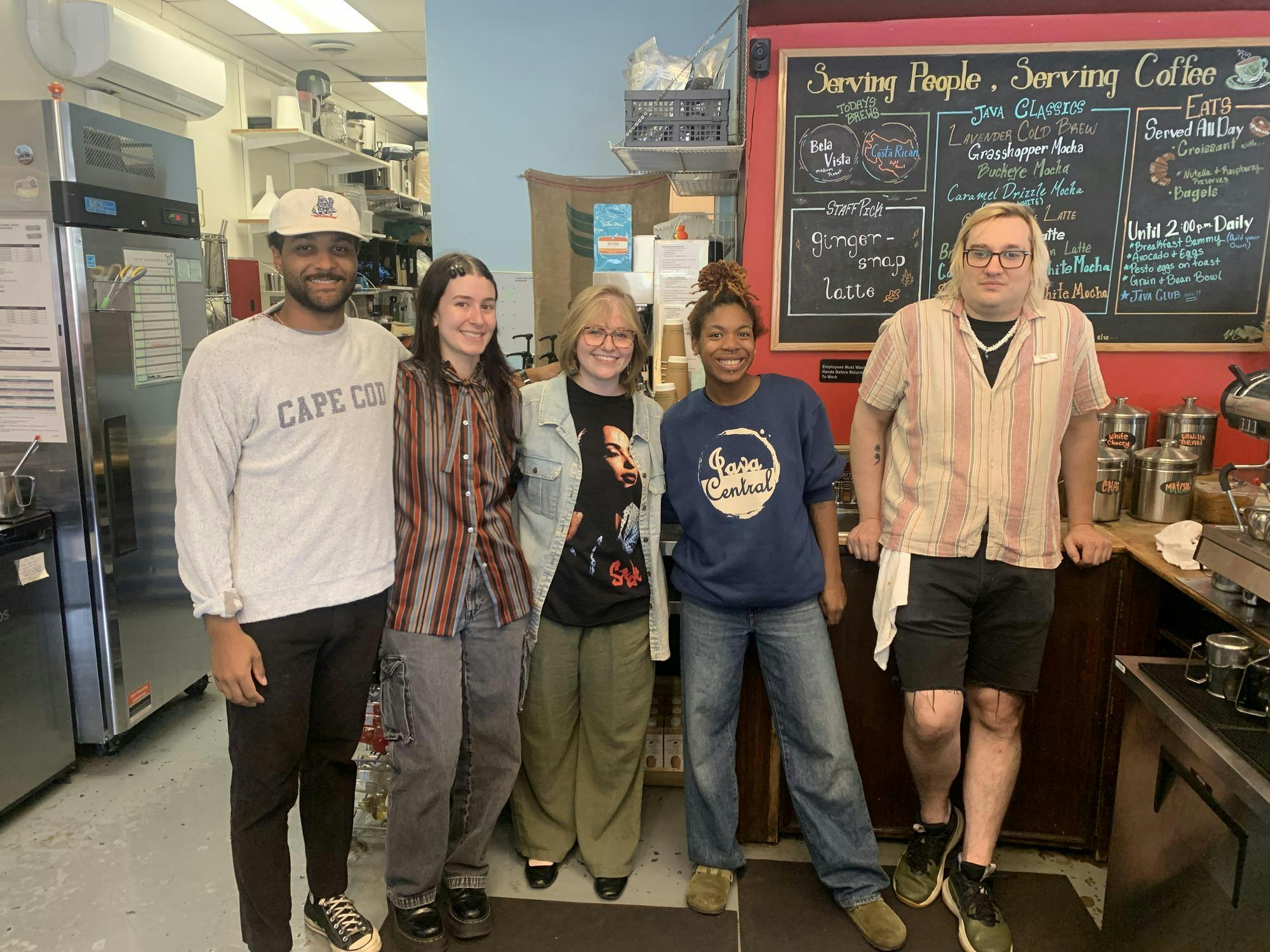 5 people standing in line smiling for a photo.