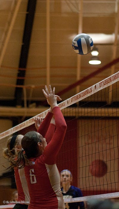 	Tabatha Piper and Kim Barker go up for a block.
