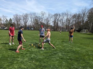 Students partake in spikeball before the total eclipse watch party at the Memorial Stadium.