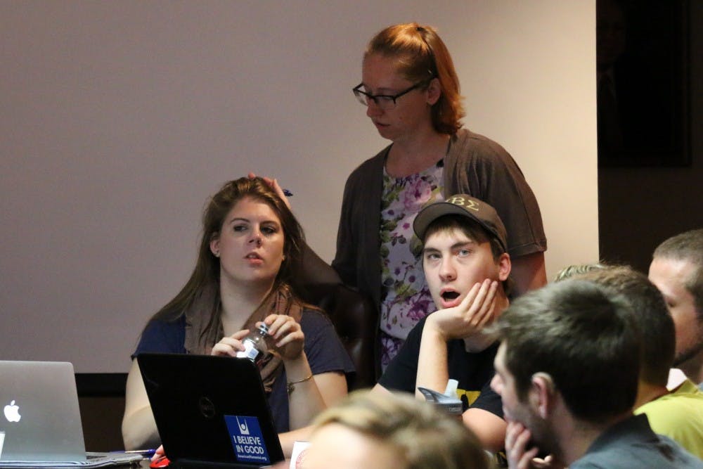<p>Student Government President Carrie Coisman, Student Government Vice President Connor Dunn and Student Government Adviser Colette Masterson begin to convene the second Student Government meeting of the 2015-2016 academic year.</p>