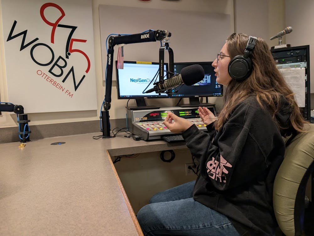 Posed photo of Angelina Godfrey talking in the WOBN station