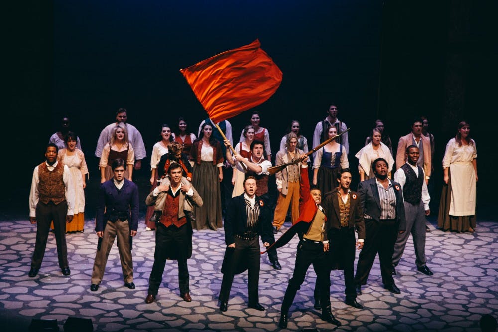 	The students of the revolution come to the iconic Les Miserables pyramid during the dramatic end to the first act. The revolutionaries are led by Enjolras, played by junior musical theatre major Jared Howelton. 