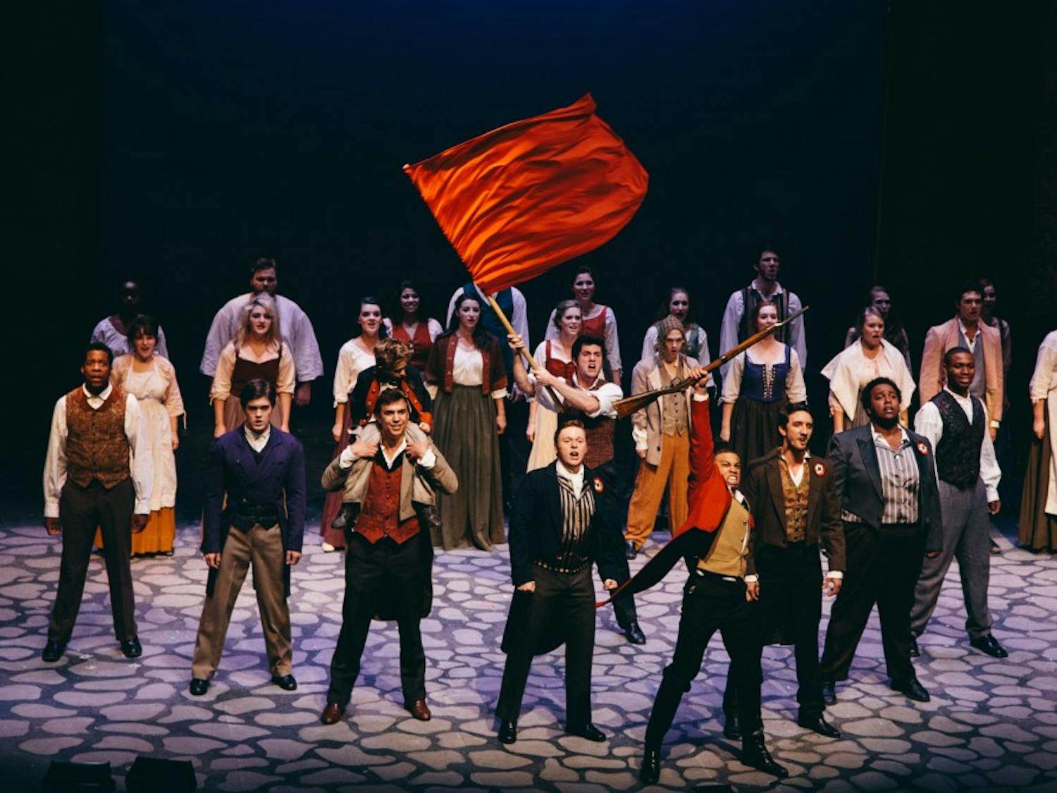 	The students of the revolution come to the iconic Les Miserables pyramid during the dramatic end to the first act. The revolutionaries are led by Enjolras, played by junior musical theatre major Jared Howelton. 
