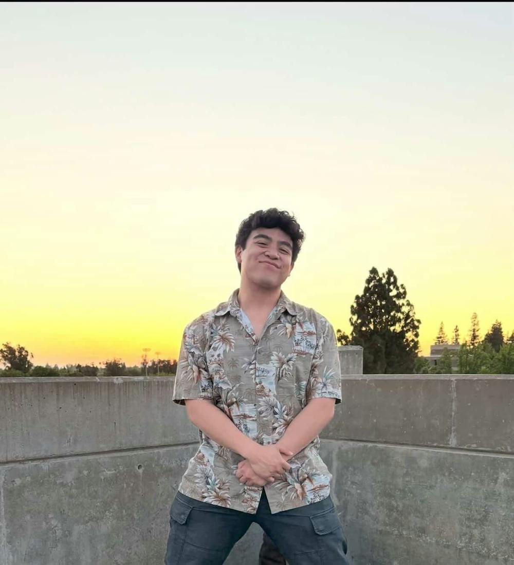 <p>Standing on top of a parking garage in Moraga, Gavin Juni poses for a picture</p>