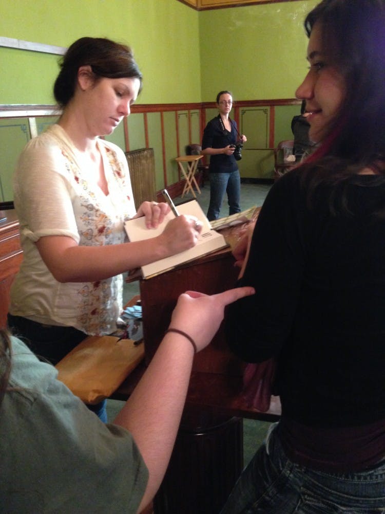 	Visiting author and 2001 Otterbein graduate Mindy McGinnis signs student copies of her debut novel, “Not a Drop to Drink.”