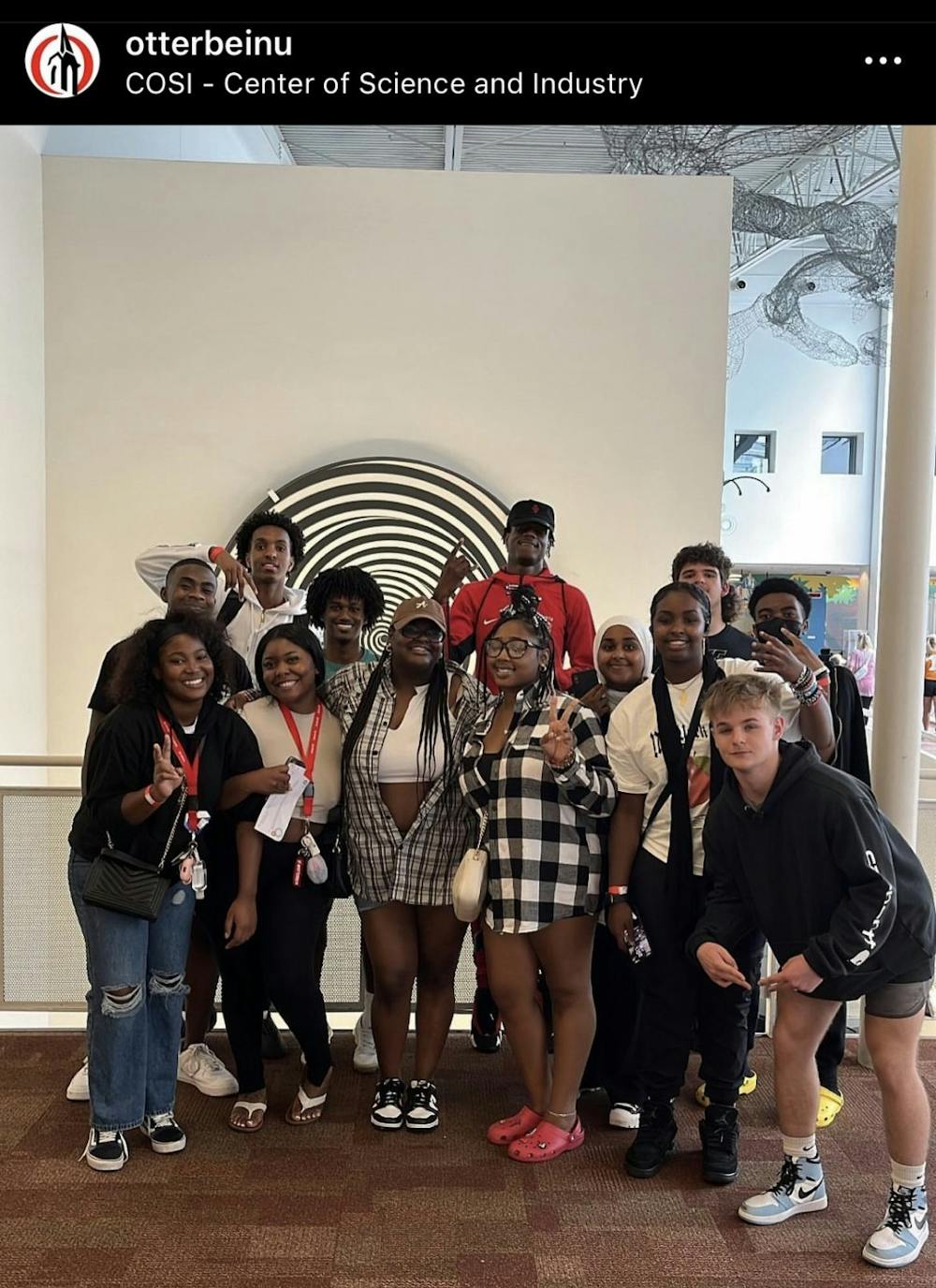 <p>Jaya Johnson (middle-left, front row) and Jennatta Mensah (middle-right, front row), are two of fall 2022's NEST mentors with some of their RISE and NEST students at COSI. This image was screenshotted from Otterbein's Instagram page.</p>