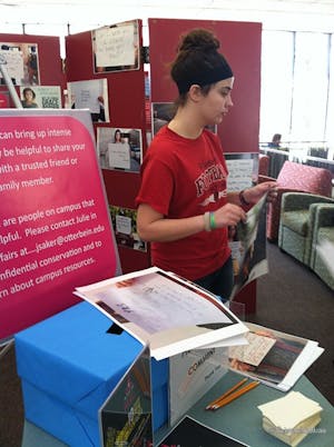 Bridgit Kern, a sophomore economics major, helped set up Project Unbreakable on the second floor of the library.
