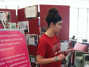 	Bridgit Kern, a sophomore economics major, helped set up Project Unbreakable on the second floor of the library.