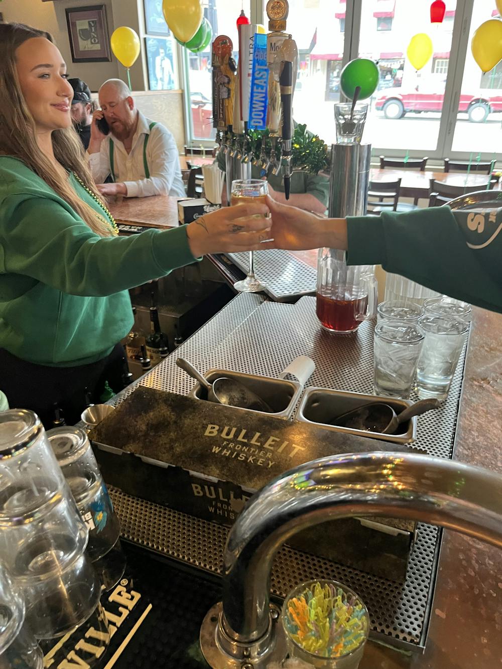 Picture of bartender at Jimmy V's Bar and Pub handing alcohol to customer