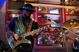 A man playing a guitar on stage 
