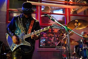 A man playing guitar on stage 