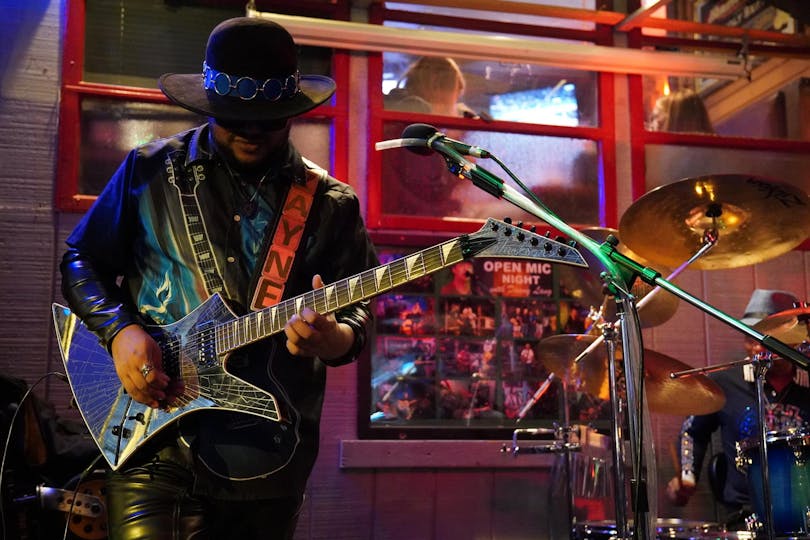 A man playing guitar on stage 