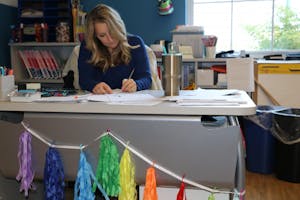 Sandy Light works on her own homework during her lunch break