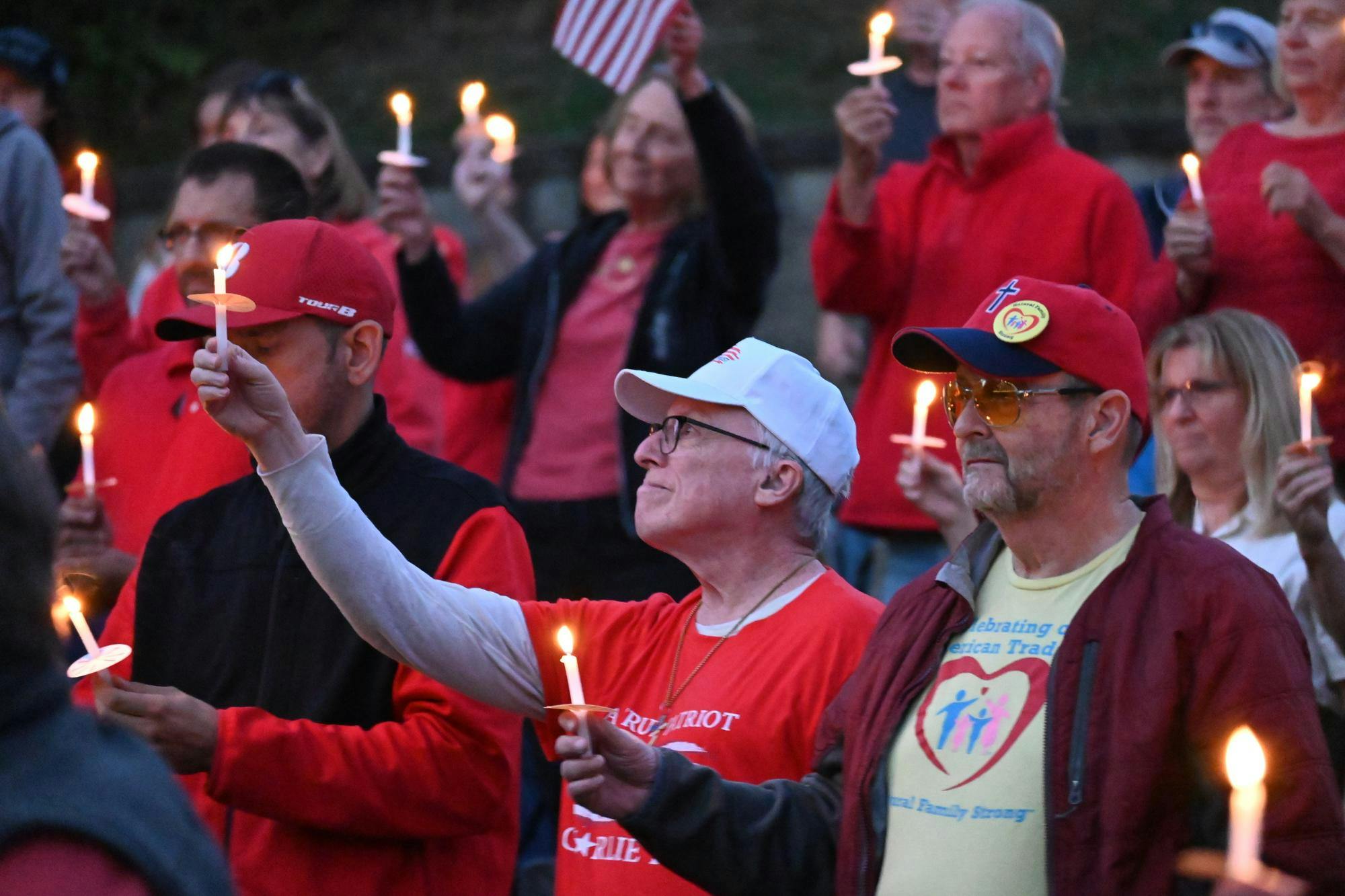 A crowd of people holding candles