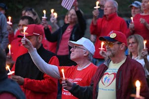 A crowd of people holding candles