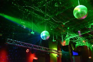 Image of two disco balls shining in green, blue, and teal strobe lights at Skully’s Music Bar. Photo taken by Angelina Godfrey on Feb. 23, 2025