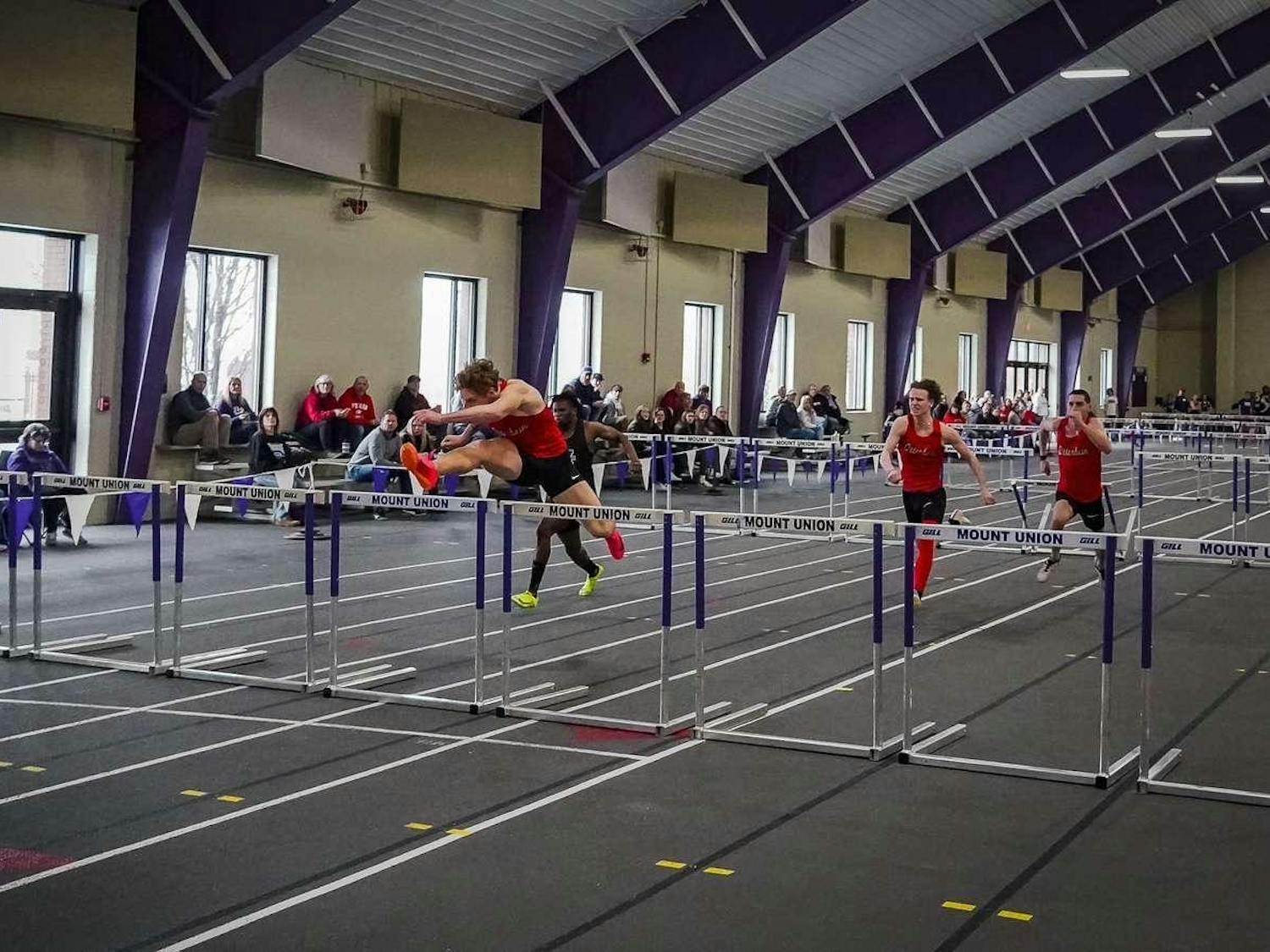 Izacc Swope leaping over a hurdle at Mount Union Indoor Meet