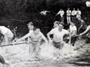 students from 1958 in alum creek playing tug of war.