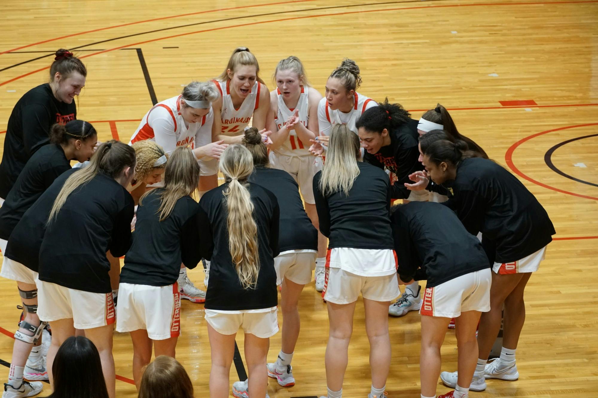 Otterbein women's basketball huddles before game in the Rike Center