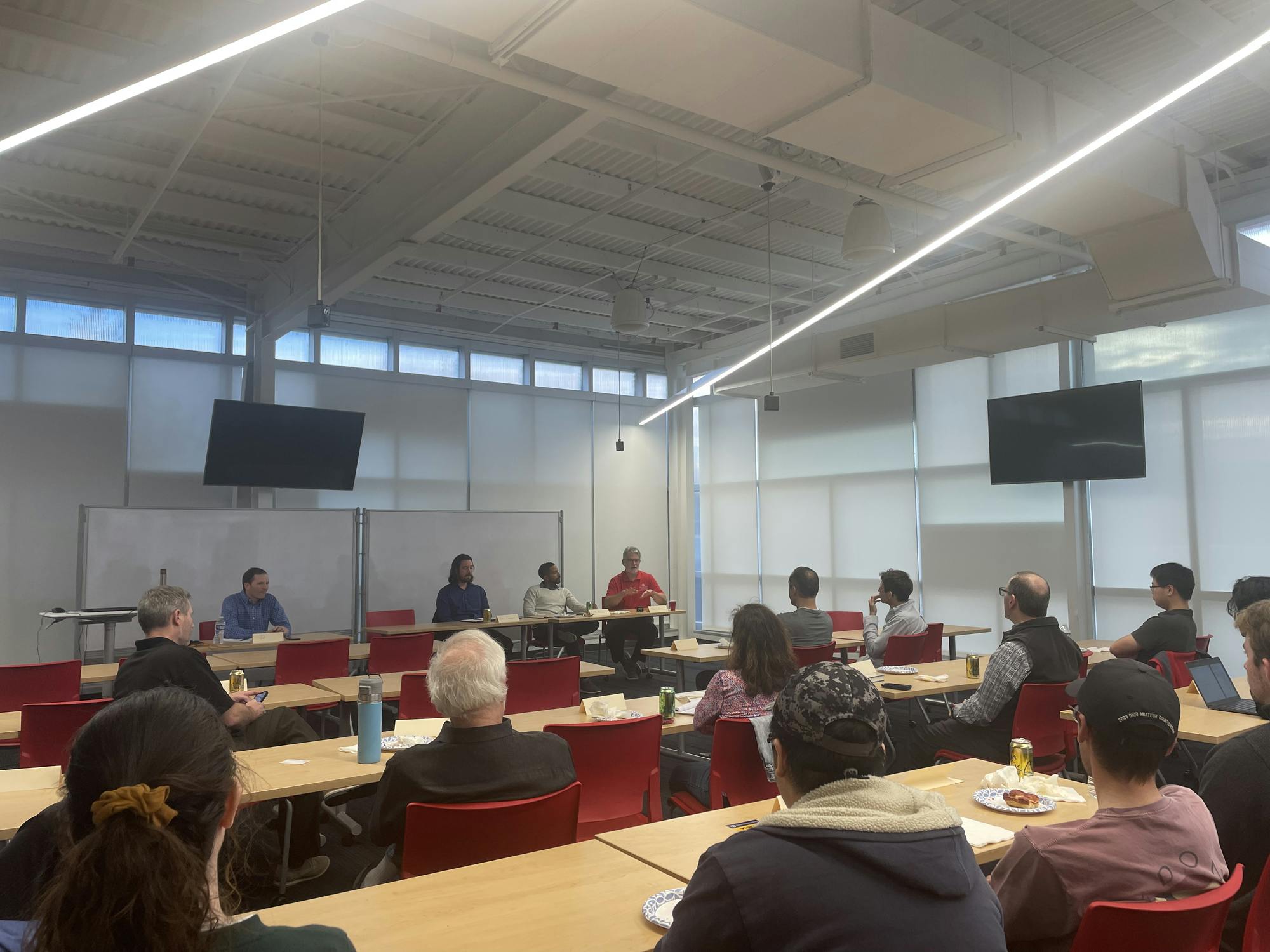 Otterbein students and faculty seated and listening to a guided discussion with four local experts in the topic of artificial intelligence.