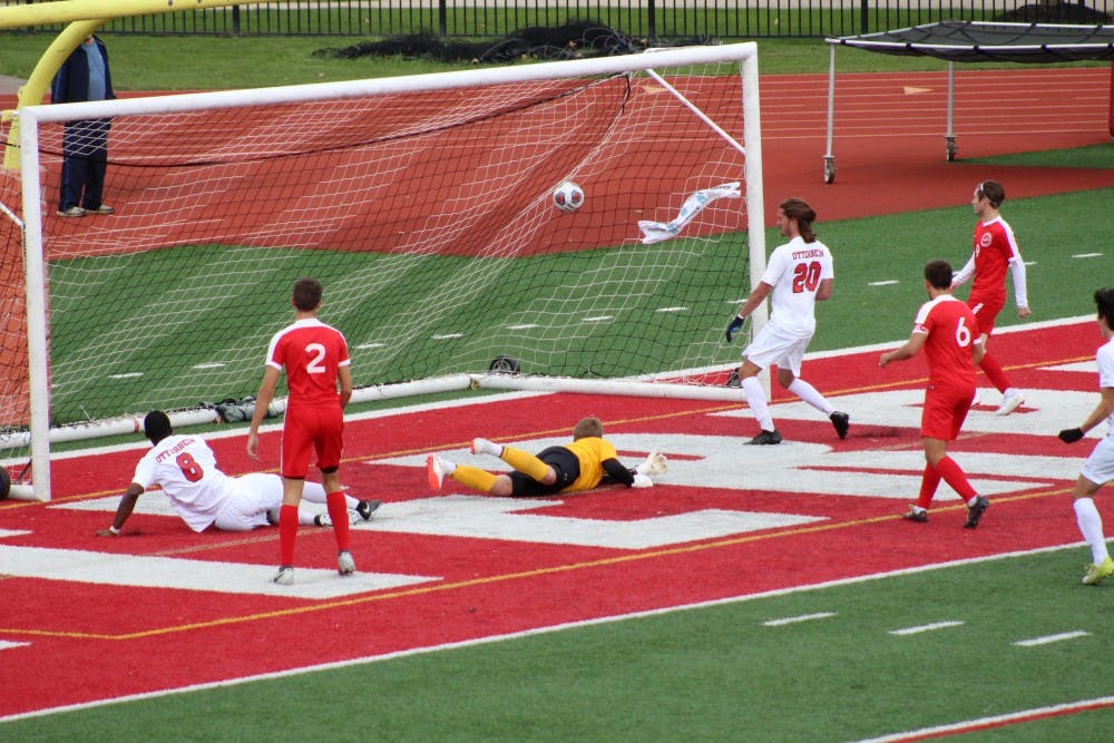 Players from both teams watch as the ball glides into the net for Otterbein's fifth goal. This was the final goal of the game and was scored by #8, Kamal Mohammed.