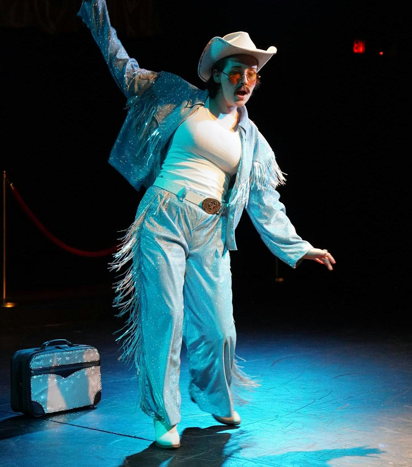A performer takes the stage with a Wild West-inspired outfit during a rehearsal for the show. 