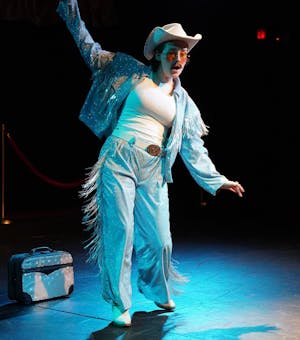 A performer takes the stage with a Wild West-inspired outfit during a rehearsal for the show. 