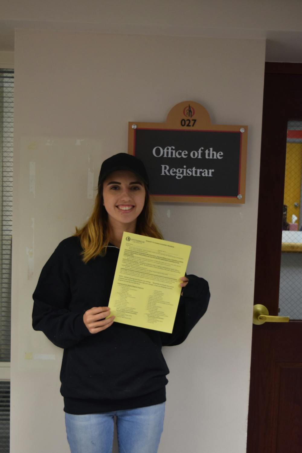 <p>Madi O'Neill outside the Registrar's Office.</p>