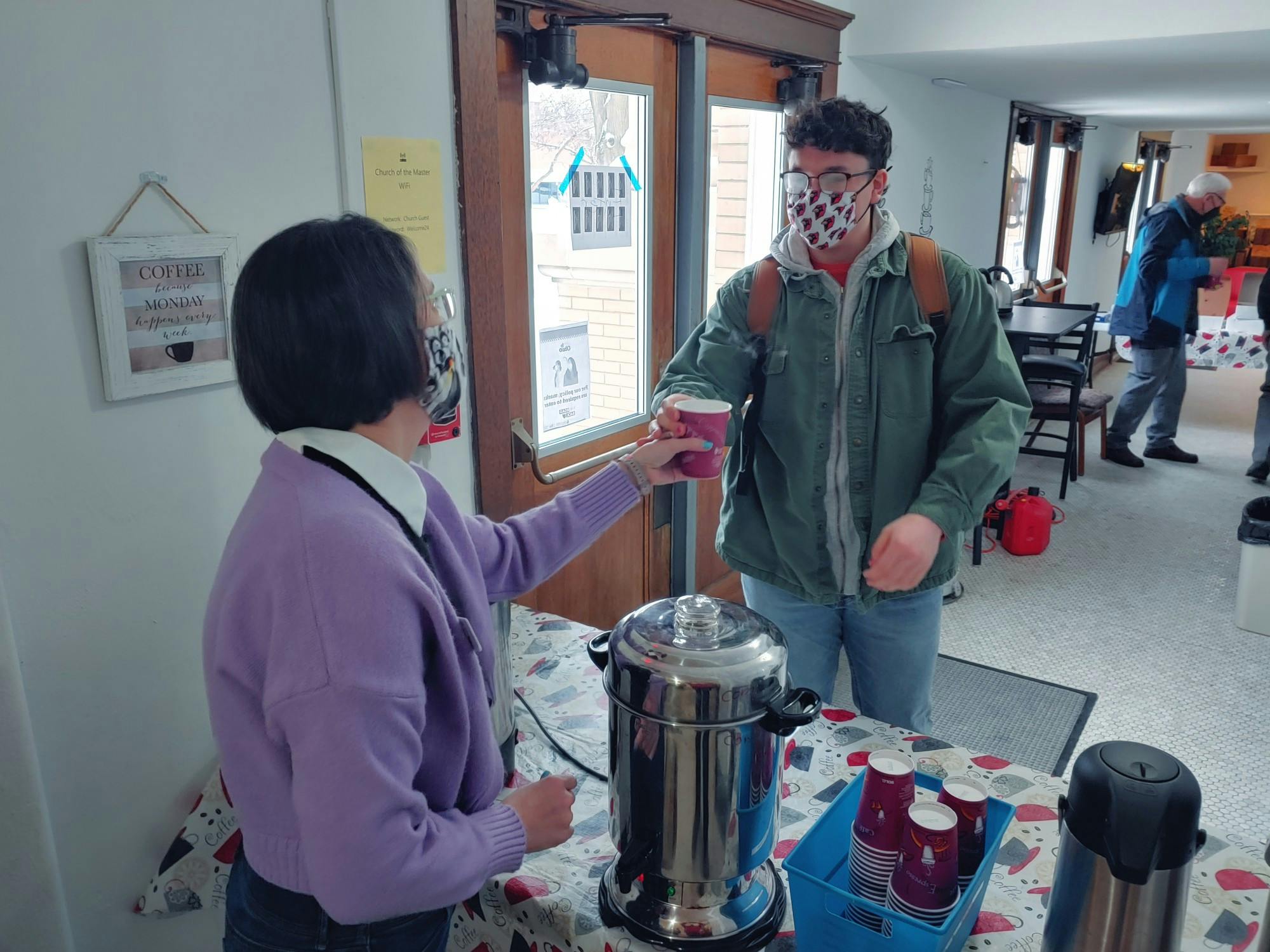 Carter Graham accepts his weekly cup from Pastor Kelly