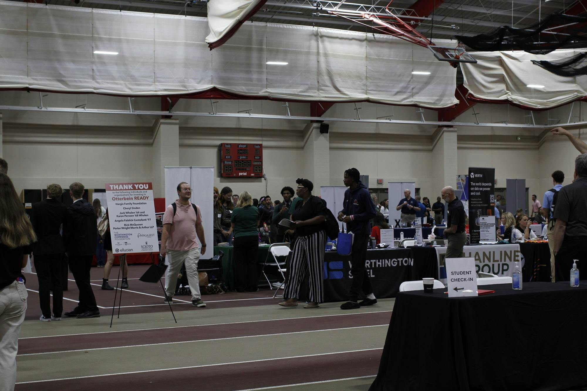 A large crowd of people inside the Clements Rec Center, which is set up with tables and signs