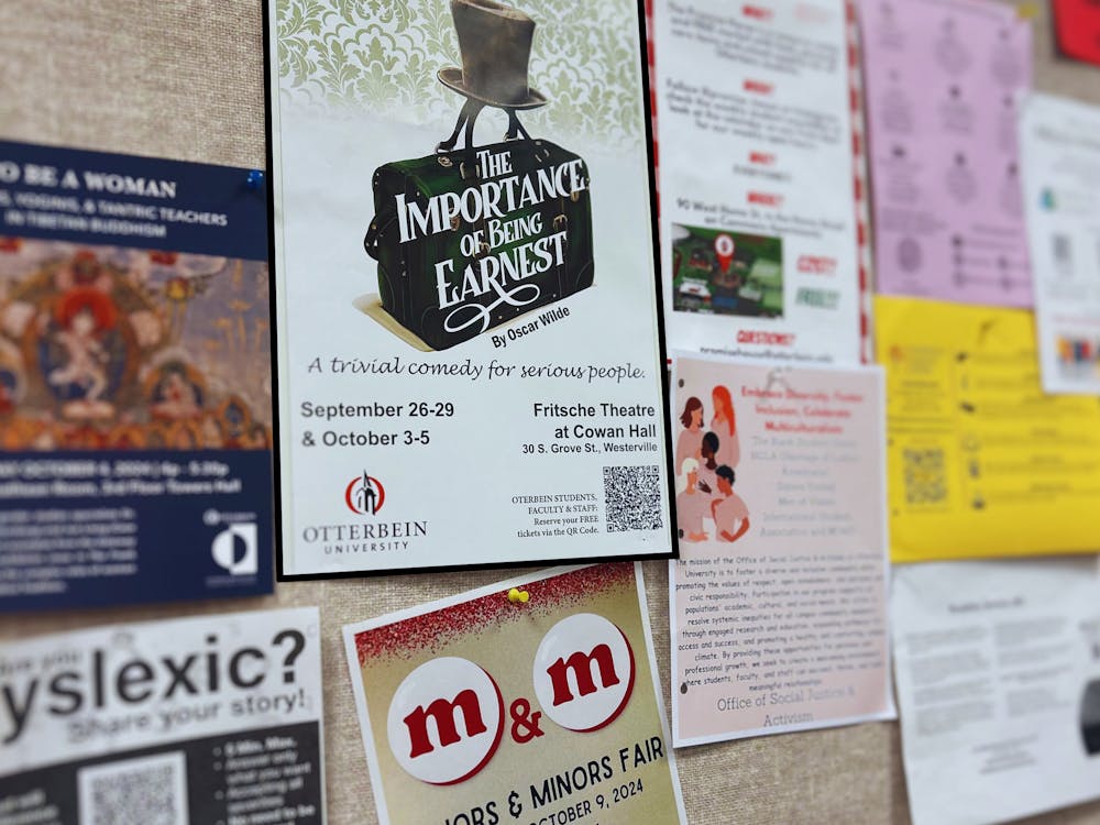 Poster promoting "The Importance of Being Earnest" production posted on bulletin board. 