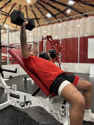 Transfer football player lifting in the weight room