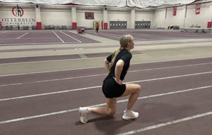 A blonde girl doing lunges.