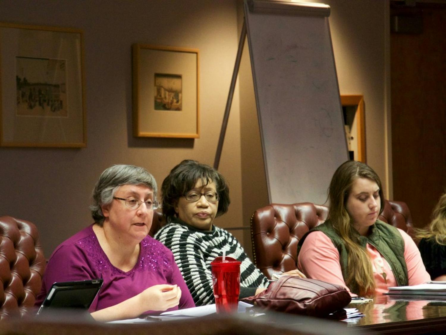 Members of the Curriculum Committee discuss changes.