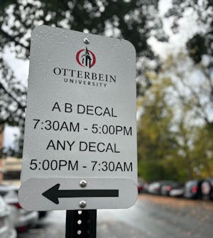 A parking sign in Mayne Hall reads "A B Decal 7:30 AM-5:00 PM." Under that, it reads, "Any Decal 5:00 PM-7:30 AM."