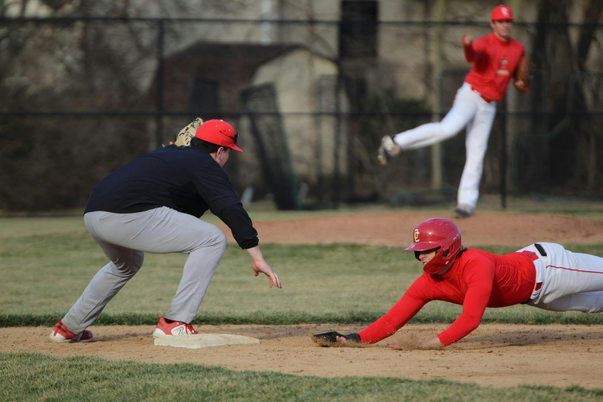 The player on base slid back to the first base in an attempt to be safe.