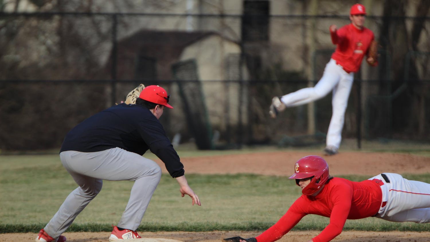 The player on base slid back to the first base in an attempt to be safe.