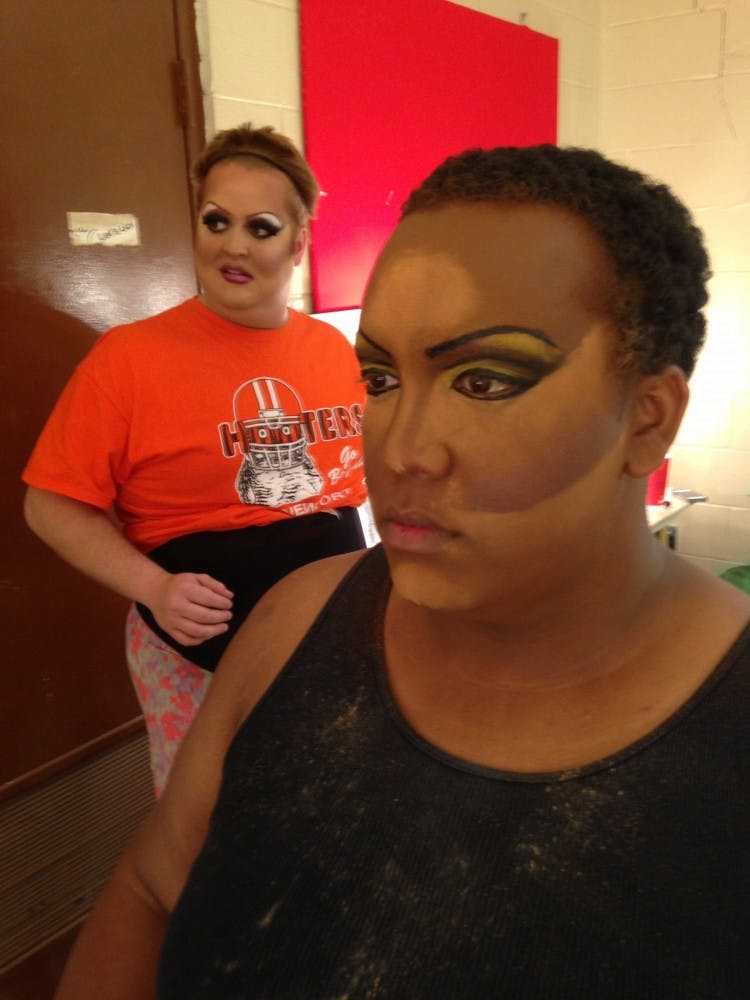 	Anthony Murphy, right, who performs as Shelita Buffet in the drag queen show, checks his makeup in the mirror. 