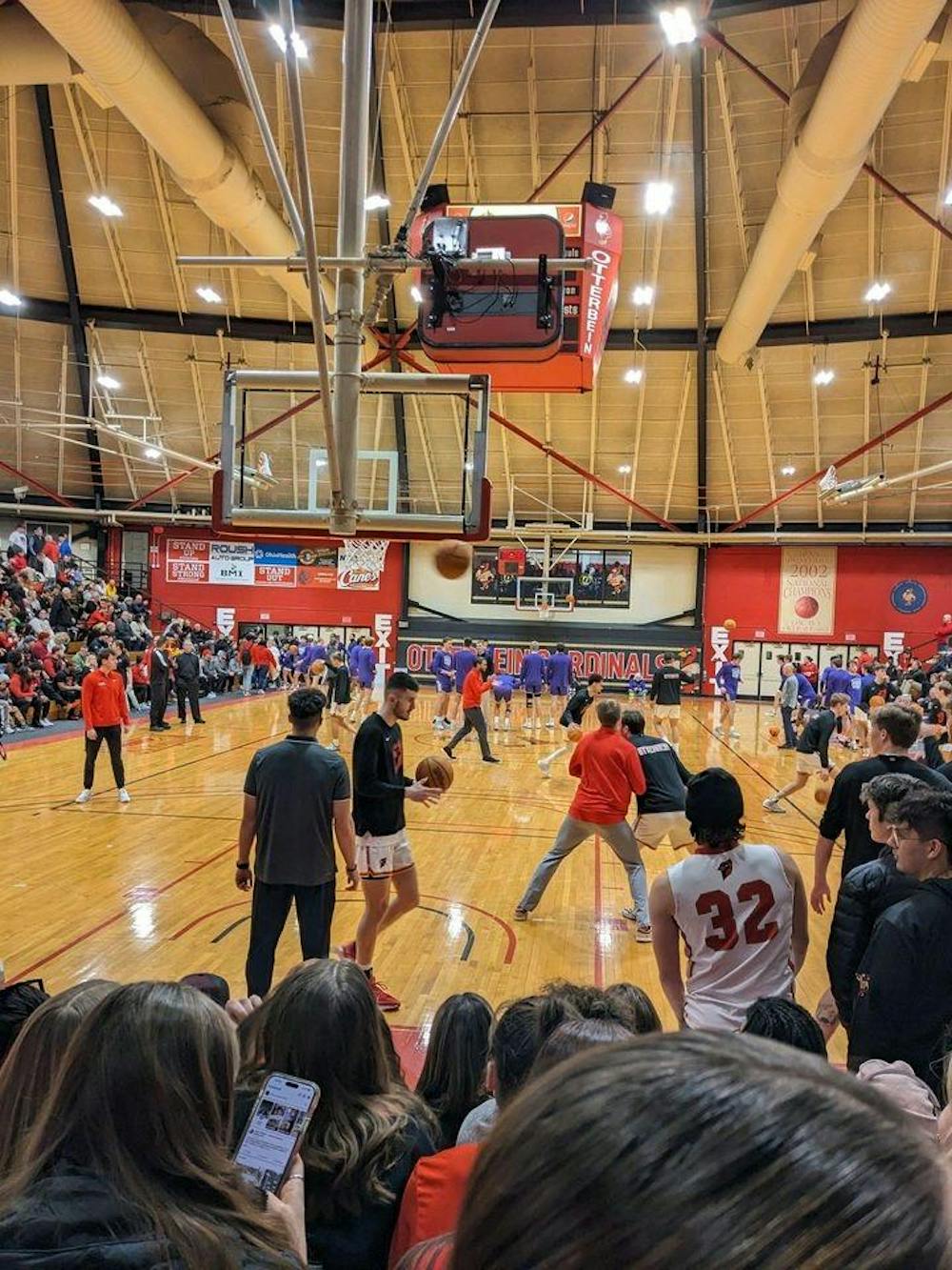 Otterbein men's basketball warms up at the start of the rivalry game against Capital 