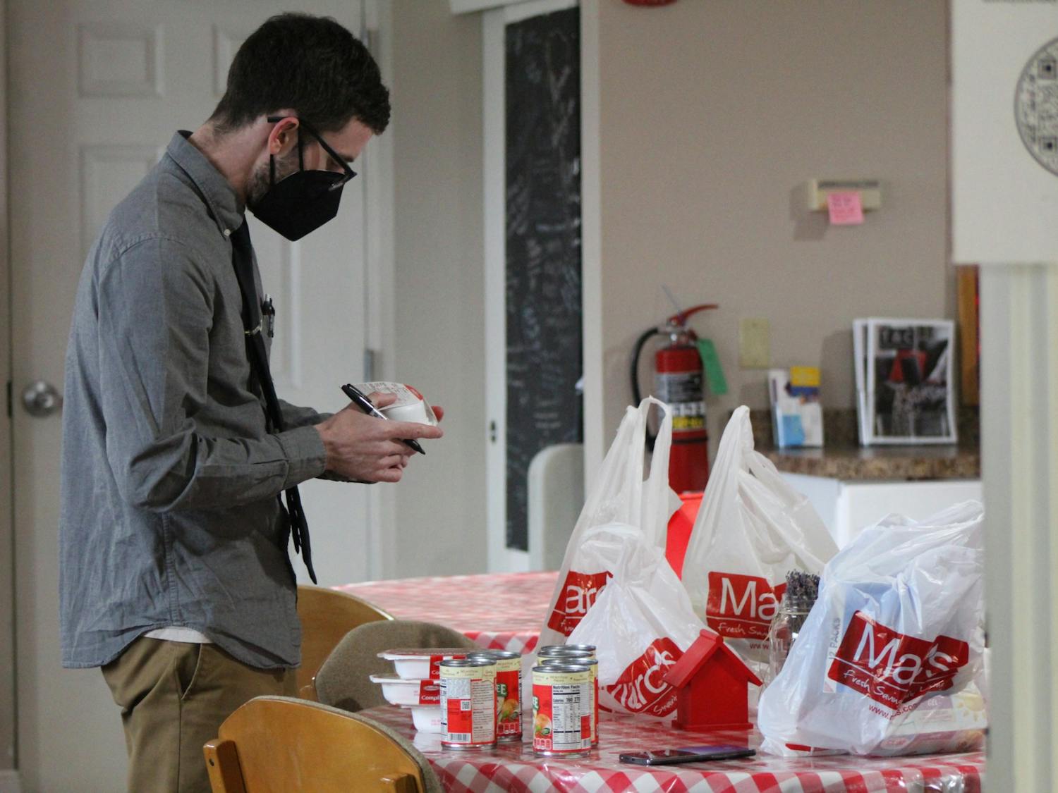 Wesley Engel, Resource Manager at the Promise House, takes stock of the inventory and checks expiration dates.